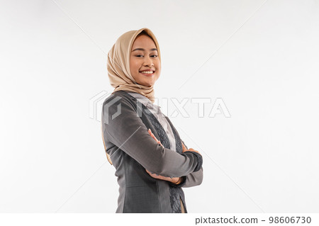 a beautiful woman with hijab standing looking down with hand crossed 98606730