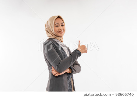 a beautiful woman with hijab standing with thumb up and cheerful face 98606740