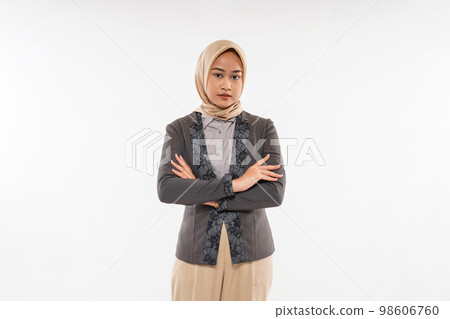 woman with hijab standing with solemn expression and crossed her hands 98606760