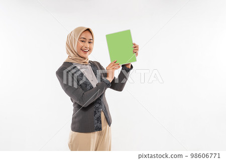 a woman with hijab standing and showing the tablet at her hand 98606771