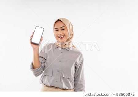 woman with hijab standing with smile while raising and showing the phone woman with hijab standing with smile while raising and showing the phone 98606872