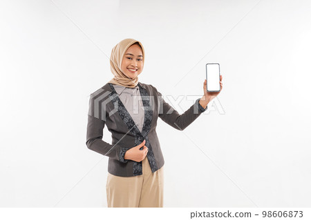 a beautiful woman with hijab showing the phone and smiling 98606873