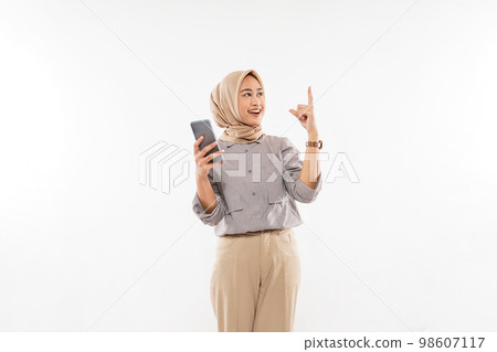 a young woman with hijab standing raising her hand a young woman with hijab standing raising her hand 98607117