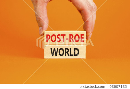 Roe vs Wade post-Roe world symbol. Concept words Post-Roe world on wooden blocks on a beautiful orange background. Businessman hand. Business and Roe vs Wade post-Roe world concept. Copy space. Roe vs Wade post-Roe world symbol. Concept words Post-Roe world on wooden blocks on a beautiful orange background. Businessman hand. Business and Roe vs Wade post-Roe world concept. Copy space. 98607183