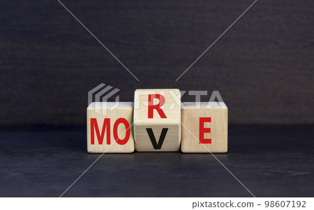 More move symbol. Concept word More move on wooden cubes. Beautiful black table black background. Business and more move concept. Copy space. More move symbol. Concept word More move on wooden cubes. Beautiful black table black background. Business and more move concept. Copy space. 98607192