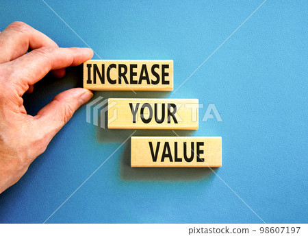 Increase your value symbol. Concept words Increase your value on wooden blocks on a beautiful blue table blue background. Businessman hand. Business increase your value concept. Copy space. Increase your value symbol. Concept words Increase your value on wooden blocks on a beautiful blue table blue background. Businessman hand. Business increase your value concept. Copy space. 98607197