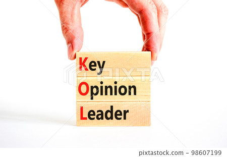 KOL key opinion leader symbol. Concept words KOL key opinion leader on wooden blocks on a beautiful white table white background. Businessman hand. Business KOL key opinion leader concept. Copy space. 98607199