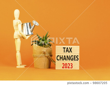Tax changes 2023 symbol. Concept words Tax changes 2023 on wooden blocks on a beautiful orange table orange background. Businessman icon. Business Tax changes 2023 concept. Copy space. Tax changes 2023 symbol. Concept words Tax changes 2023 on wooden blocks on a beautiful orange table orange background. Businessman icon. Business Tax changes 2023 concept. Copy space. 98607205