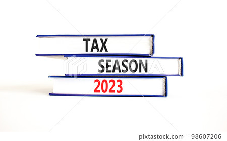 Tax season 2023 symbol. Concept words Tax season 2023 on books on a beautiful white table white background. Business Tax season 2023 concept. Copy space. Tax season 2023 symbol. Concept words Tax season 2023 on books on a beautiful white table white background. Business Tax season 2023 concept. Copy space. 98607206