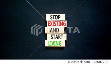 Stop existing start living symbol. Concept words Stop existing and start living on wooden blocks. Beautiful black table black background. Business Stop existing start living concept. Copy space. Stop existing start living symbol. Concept words Stop existing and start living on wooden blocks. Beautiful black table black background. Business Stop existing start living concept. Copy space. 98607228