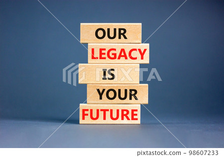 Legacy and future symbol. Concept words Our legacy is your future on wooden blocks. Beautiful grey table grey background. Business legacy and future concept. Copy space. 98607233