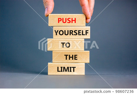 Push the limit symbol. Concept words Push yourself to the limit on wooden blocks. Beautiful grey table grey background. Businessman hand. Business push the limit concept. Copy space. Push the limit symbol. Concept words Push yourself to the limit on wooden blocks. Beautiful grey table grey background. Businessman hand. Business push the limit concept. Copy space. 98607236