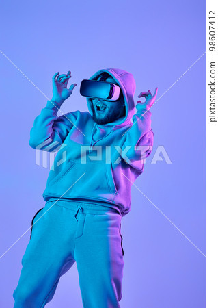 man using virtual reality glasses and playing video games 98607412