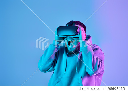 man using virtual reality glasses and playing video games man using virtual reality glasses and playing video games 98607413