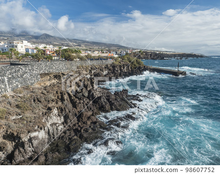 View of Alcala village, part of Guya de Isora municipality, with traditional architecture and sharp lava rock coast with small pier. Tenerife, Canary Islands, Spain View of Alcala village, part of Guya de Isora municipality, with traditional architecture and sharp lava rock coast with small pier. Tenerife, Canary Islands, Spain 98607752