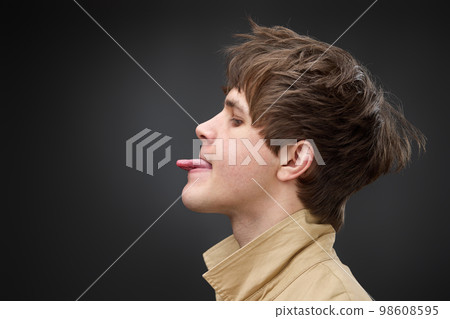 portrait of caucasian man with hairstyle in coat 98608595