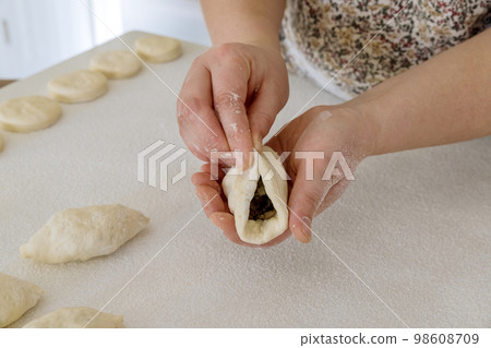 Making homemade buns with potatoes from yeast dough on white countertop in kitchen 98608709