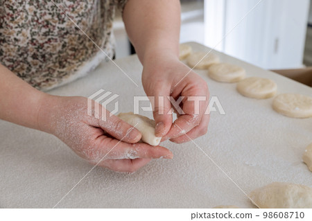 On white countertop homemade bun is being made with potatoes and yeast dough 98608710