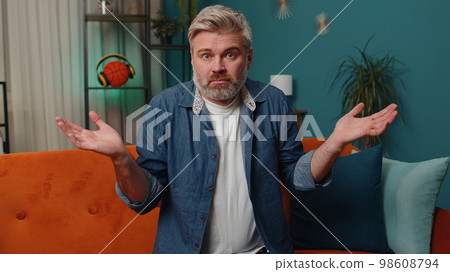 Confused middle-aged mature man feeling embarrassed about ambiguous question, having doubts, no idea Confused middle-aged mature man feeling embarrassed about ambiguous question, having doubts, no idea 98608794