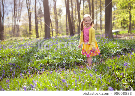 Child with bluebell flowers in spring forest Child with bluebell flowers in spring forest 98608888
