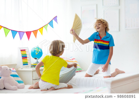 Kids pillow fight. Bedroom for two children. Kids pillow fight. Bedroom for two children. 98608891