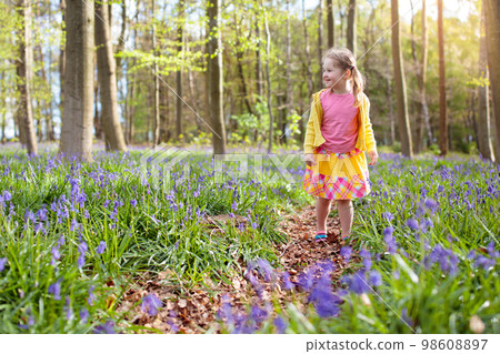 Child with bluebell flowers in spring forest Child with bluebell flowers in spring forest 98608897