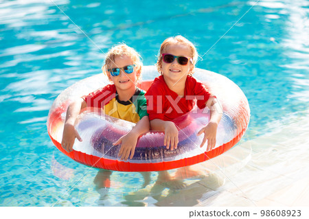 Kids in swimming pool. Life jacket for child. Kids in swimming pool. Life jacket for child. 98608923