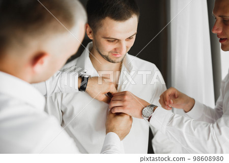 Beautiful man, groom posing and preparing for wedding Beautiful man, groom posing and preparing for wedding 98608980