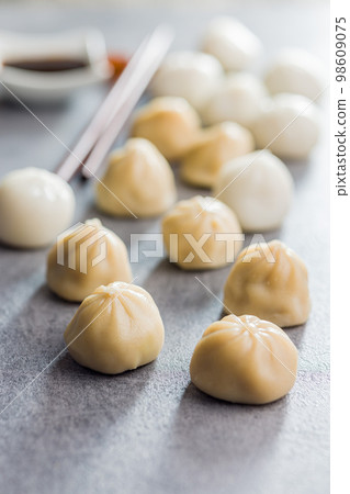 Xiaolongbao, traditional steamed dumplings. Xiao Long Bao buns on kitchen table. 98609075