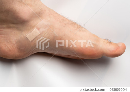 Medical bandage on human leg Medical bandage on human leg 98609904