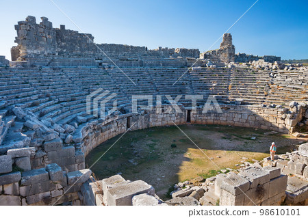 Woman looking at theater of Xanthos ancient city 98610101