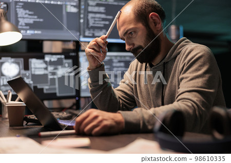 Pensive coder brainstorming ideas to find source code and develop html script on terminal window. Thinking about solution to create cloud computing server interface, coding program. 98610335