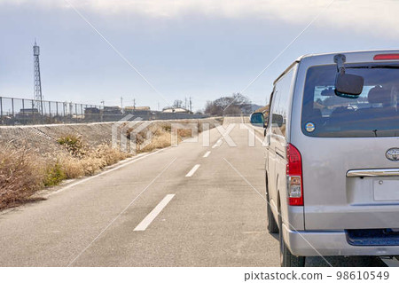 Scenery of a one-box car used for delivery and sales and an industrial area Scenery of a one-box car used for delivery and sales and an industrial area 98610549