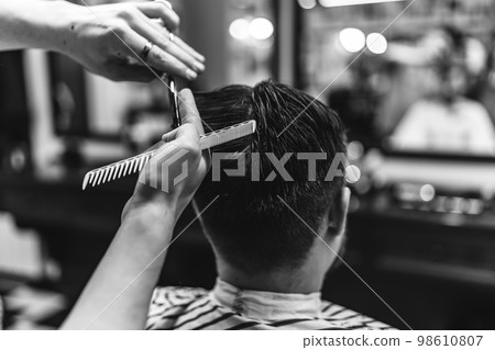 Men's haircut in a barbershop. 98610807