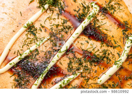Shrimp rice cracker arrangement. Okonomiyaki style with sauce, mayonnaise and green laver. Shrimp rice cracker arrangement. Okonomiyaki style with sauce, mayonnaise and green laver. 98610992