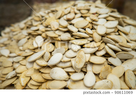 Mountains of pumpkin seeds. Healthy diet. On the counter of the store. Mountains of pumpkin seeds. Healthy diet. On the counter of the store. 98611069