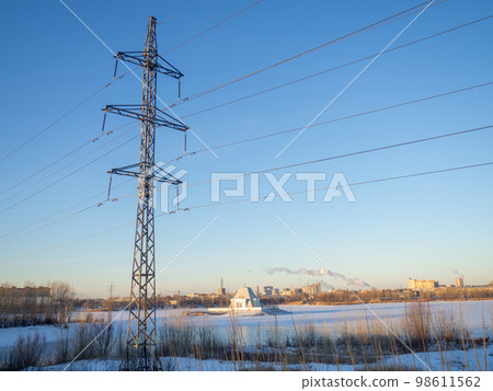 Power line. Pillar. Metal tower. Electricity in the city. 98611562
