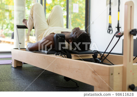 Activ middle-aged African-American man during pulling stretch band Activ middle-aged African-American man during pulling stretch band 98611628