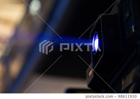 Light from the cinema spotlight broadcasting the presentation Light from the cinema spotlight broadcasting the presentation 98611910