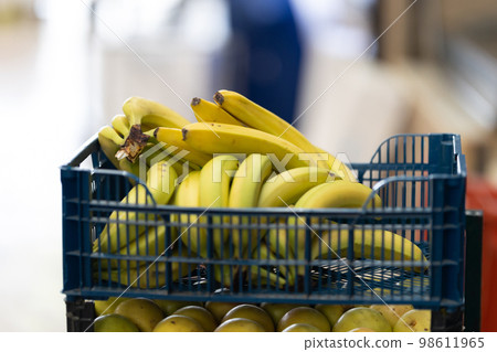 Plastic containers with bananas on the market 98611965