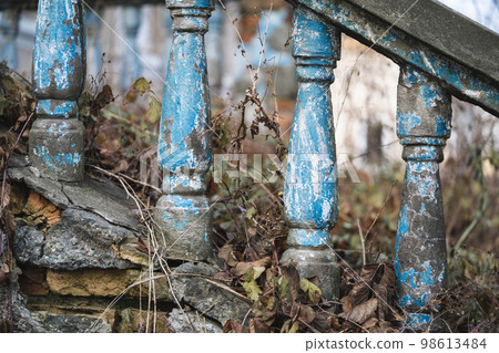 a balustrade on the railing of an old cracked staircase a balustrade on the railing of an old cracked staircase 98613484