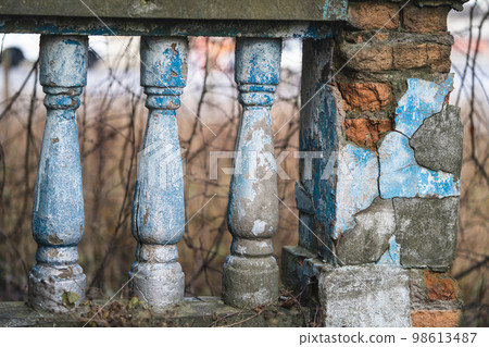a balustrade on the railing of an old cracked staircase a balustrade on the railing of an old cracked staircase 98613487