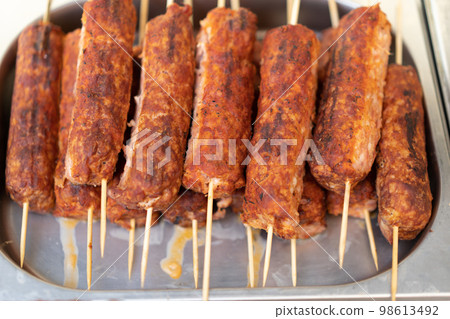 delicious grilled meat sausages on a stick delicious grilled meat sausages on a stick 98613492