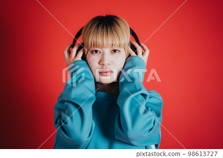 A woman listening to music A woman listening to music 98613727