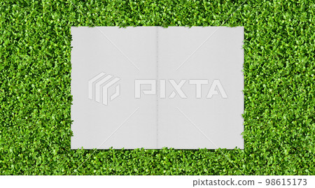 Green garden with vivid greenery and white notebook background 98615173