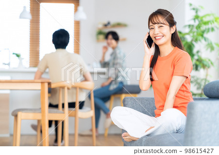 Friends men and women share house lifestyle living room Friends men and women share house lifestyle living room 98615427