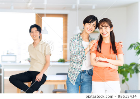 Friends men and women share house lifestyle living room 98615434