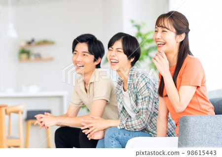 Friends men and women share house lifestyle living room 98615443