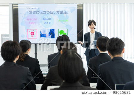 Business seminar female lecturer using the monitor 98615621