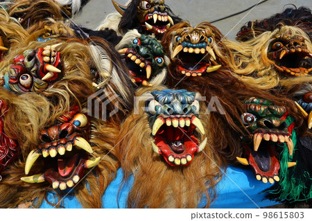 a row of wooden devil masks for Indonesian traditional dance a row of wooden devil masks for Indonesian traditional dance 98615803